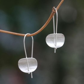 The modern, minimalist design of these earrings is by Desi Antari in Bali. She crafts the sterling silver earrings by hand and finishes them with brushed satin textures.